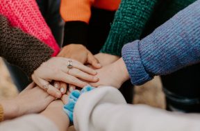 Group-of-friends-with-hands-in-centre-of-circle.jpg