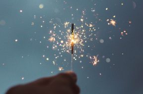 Person-holding-a-sparkler-for-New-Years.jpg