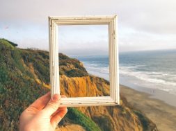 Person-holding-frame-up-to-a-landscape.jpg