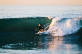 Man-surfing-by-Austin-Neill-Unsplash.jpg